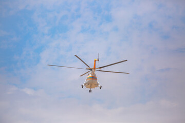 Helicopter close-up against the sky. Rescue helicopter flies in the sky with clouds.