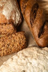 Different types of bread on canvas fabric. Vertical photo. Close-up
