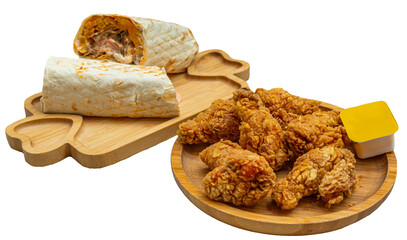 Shawarma wrap with fried chicken pieces and dipping sauce on wooden boards