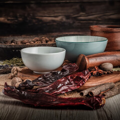 GUAJILLO CHILLI PODS on wooden table background. Herbs, spices and dried food baking ingredient. Mortar and different spices. Cottage kitchen. Product Photography