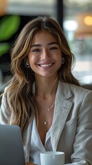 Smiling Businesswoman with Long Hair in Light Blazer Working on Laptop
