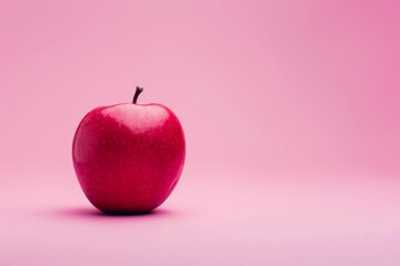 red apple isolated on a pink background