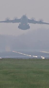 heavy military transport airplane toke off taking off departure departing runway generic airport bad weather cloudy foggy