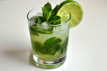 Refreshing mojito with lime wedges and mint leaves 