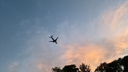 Airplane in the sky at sunset