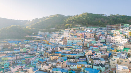 the aerial view of Gamcheon Culture Village in Busan, Korea, showcasing a vibrant mosaic of densely packed colorful houses and winding streets.