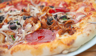 Closeup of pizza on a plate on table. No people.