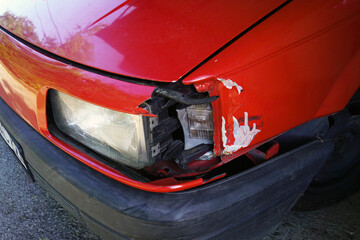 Side view of a car after a minor accident - close-up photo of a broken turn signal and damaged wing.