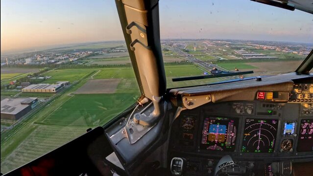 Landing seen forward view from cockpit of aircraft, airplane, jet plane from holiday destination and many instruments and controls on the flight deck Amsterdam airport Schiphol