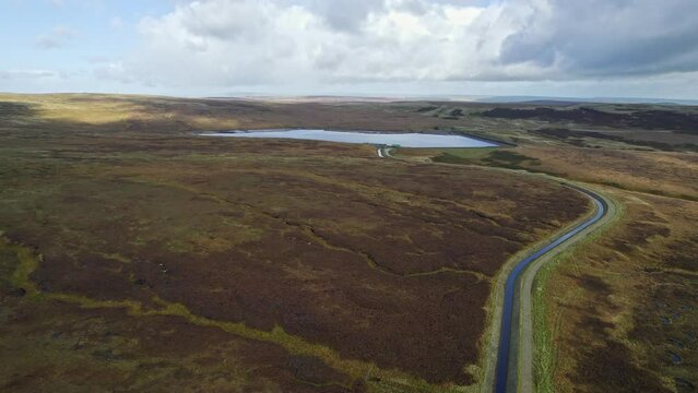 Aerial drone, cinematic footage of a country winding road on Saddleworth Moor