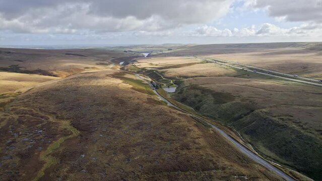 Aerial drone, cinematic footage of a country winding road on Saddleworth Moor