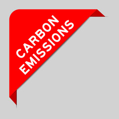 Red color of corner label banner with word carbon emissions on gray background