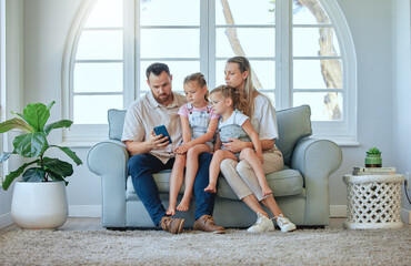 Cellphone, family and together for reading, couch and online for message, living room and parents. Home, man and woman with kids, mobile and sofa for mother, father and children and connection