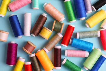 Threads for sewing in different colors on a colored background