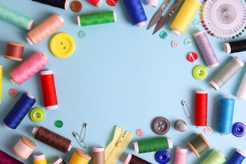 A wide range of sewing materials and tools is located on a colored background