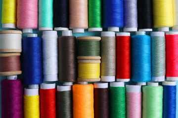 Threads for sewing in different colors on a colored background