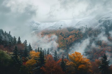 A breathtaking mountain range shrouded in clouds and mist, with snow-capped peaks reaching towards the sky. The valley below is filled with dense forests of evergreens and vibrant autumn foliage