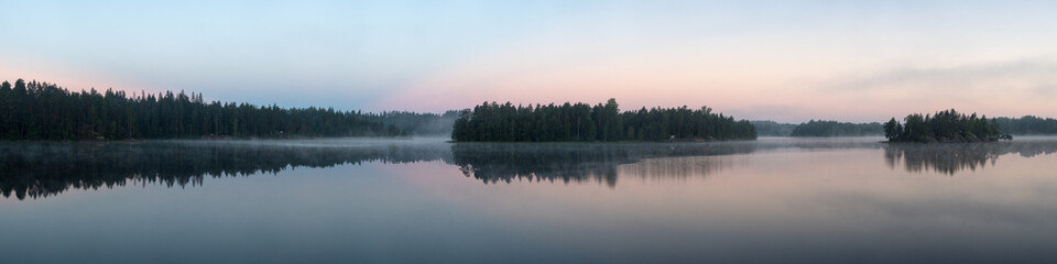 panorama of a forest lake with fog