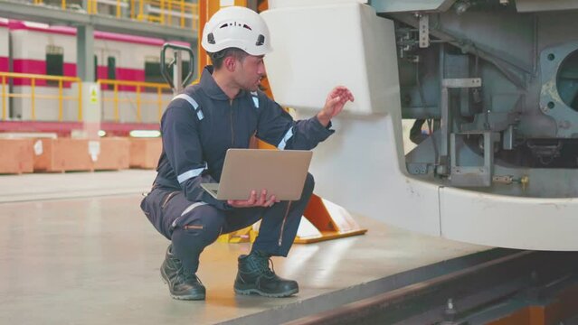 Engineers check the readiness of electric train tracks at the maintenance factory.
