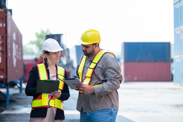 Engineers check the product list before sending it out at the industrial container yard.