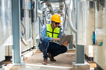An engineer checks the status of a large AHU air conditioner control valve.