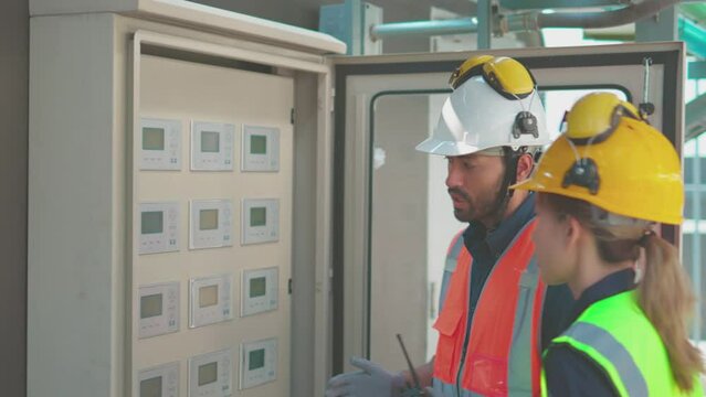 Engineer under checking the industry chilled water fan coil unit air conditioner is water cooling tower air chiller HVAC system of large industrial building to control air system

