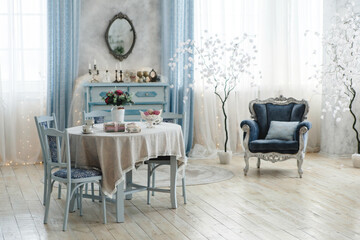 Sophisticated interior design with pastel blue furniture, lace tablecloth, and floral decor. An ornate mirror, decorative trees, and soft lighting enhance the room's charm and elegance