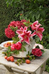 Red Lilies  and hydrangea still life in a garden