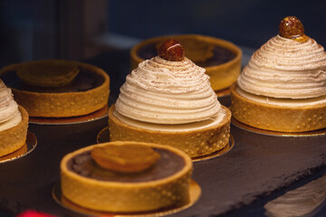 Delicious cakes with cream on display at the patisserie counter