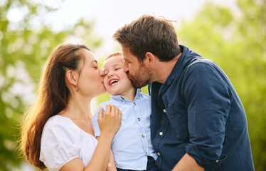 Fototapeta premium Kiss, happy and family with child outdoor park together for bonding, love and support on summer vacation. Woman, man and kid smile with care, trust and respect for childhood memory on holiday