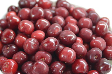 Red cherry in a bowl. Red sweet cherry background.