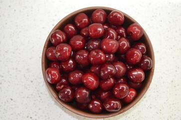 Red cherry in a bowl. Red sweet cherry background.