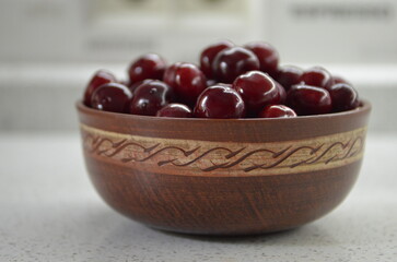 Red cherry in a bowl. Red sweet cherry background.