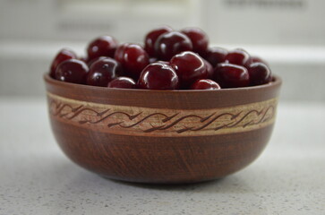 Red cherry in a bowl. Red sweet cherry background.