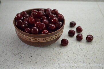 Red cherry in a bowl. Red sweet cherry background.