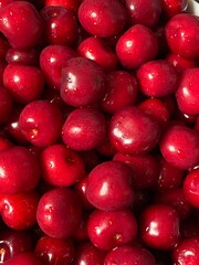 Red cherry in a bowl. Red sweet cherry background.