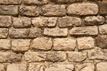 A wall of stones on mortar as a background.