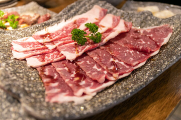 Beef slice on black tray for hot pot or grill (barbecue or yakiniku).