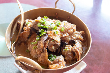Chunks of tender pork stewed with Chinese herbs and spices in a rich brown sauce, served with steamed rice.