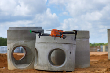 Contractor supervisor examines work on construction site using drone
