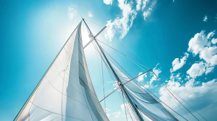 Fotobehang Sailboat mast piercing bright blue sky with white clouds © Sean