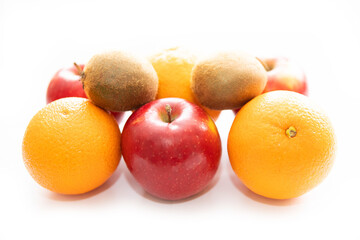 fruits on a white background, apples, oranges and kiwi