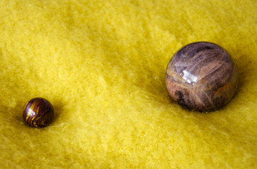 Moonstone and tiger eye spheres on yellow blanket