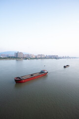 JIUJIANG, CHINA - JUNE 15, 2024: Shipping containers and bulk vessels carrying production and household goods are busy on the Jiujiang section of the "golden waterway" of the Yangtze River.
