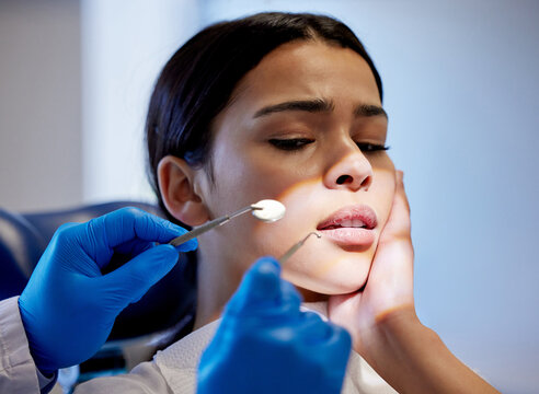 Woman, hands and scared for dental surgery in clinic with fear for teeth removal and treatment with doctor. Female person, dentist and worry or nervous in consultation with canal procedure for health