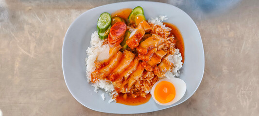 Crispy pork rice on a blue plate on the dining table