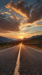 Fototapeta premium Empty old paved road in mountain area at sunset 