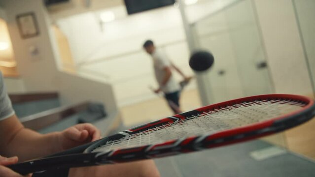 Squash players and a bouncing ball