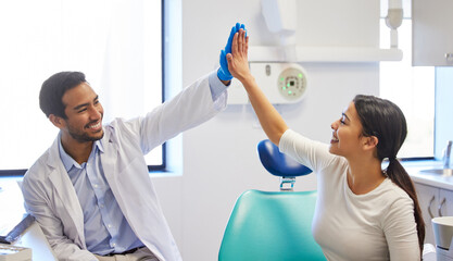 Dentist, patient and happy with high five for celebration or success of teeth whitening, oral and...