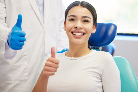Dentist, client and smile with portrait for thumbs up for success of teeth whitening, oral and dental care. Doctor, assistant and woman with hand gesture for well done or good job, yes and thank you.